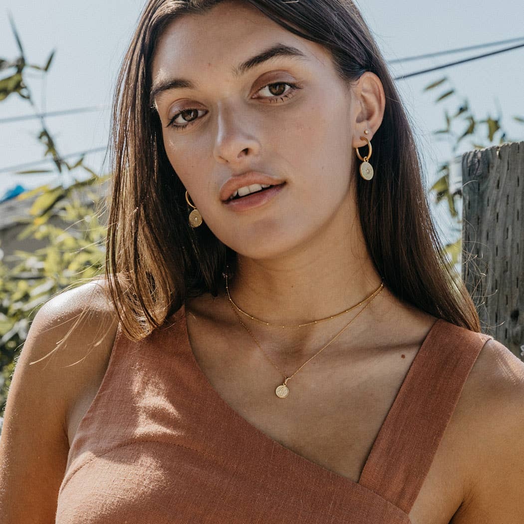 A woman in layered necklaces